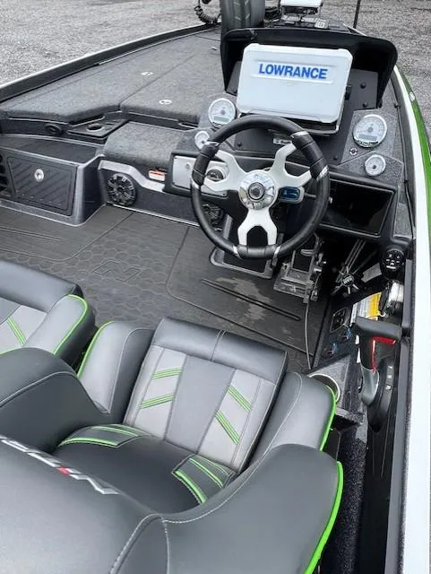 Slide: The Image of 2024 Nitro Z21 XL boat interior with steering wheel and Lowrance navigation system. - 6