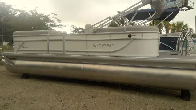 Slide: The Image of 2025 Godfrey Pontoons Xperience 2286 SBX Sport Tube, side view on land. - 1