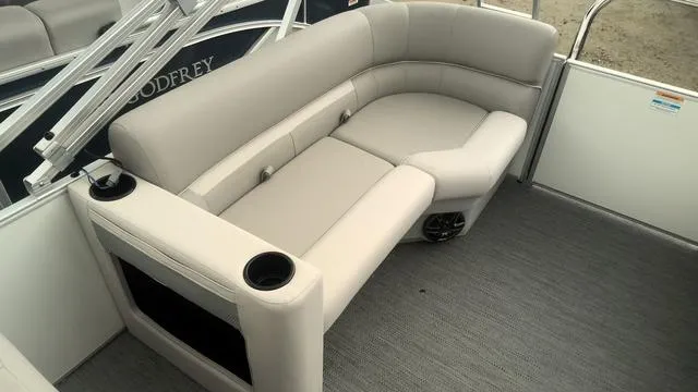 Slide: The Image of 2025 Godfrey Pontoons Xperience 2286 SBX interior with plush seating and cup holders. - 11