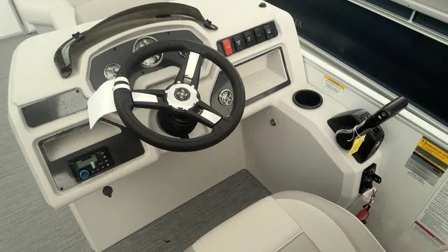 Slide: The Image of 2025 Godfrey Pontoons Xperience 2286 SBX helm with steering wheel and controls. - 7