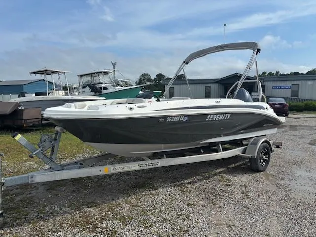 The Image of 2022 Hurricane SunDeck Sport 185 OB boat on trailer, parked outdoors. - 0