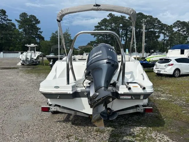 Slide: The Image of 2022 Hurricane SunDeck Sport 185 OB boat with Yamaha outboard motor, parked outdoors. - 5