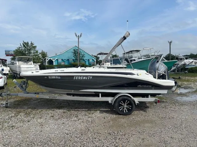 Slide: The Image of 2022 Hurricane SunDeck Sport 185 OB boat on trailer, parked outdoors. - 6