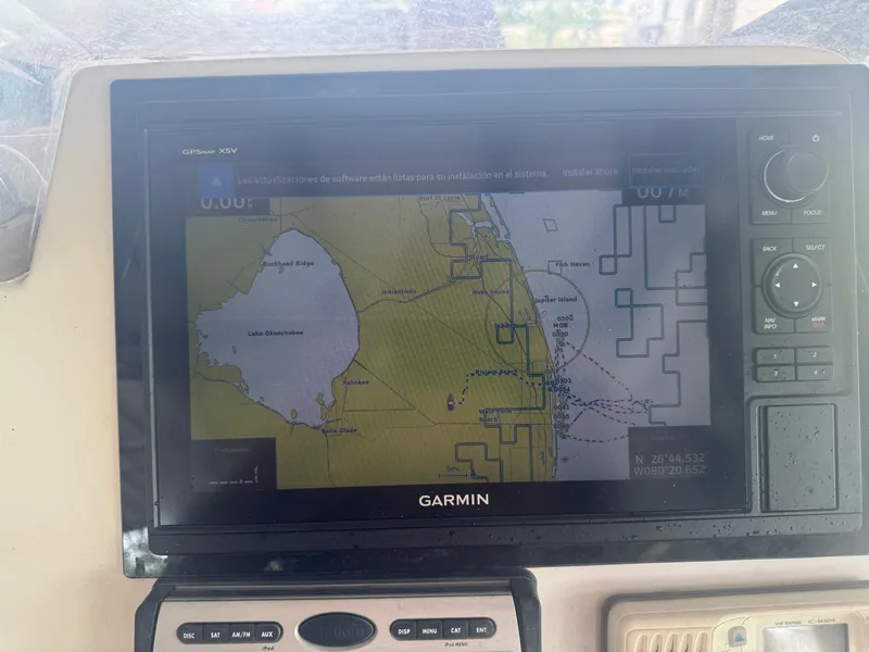 Slide: The Image of 2008 Avanti 36 boat dashboard with rod holders, under a clear blue sky. - 13