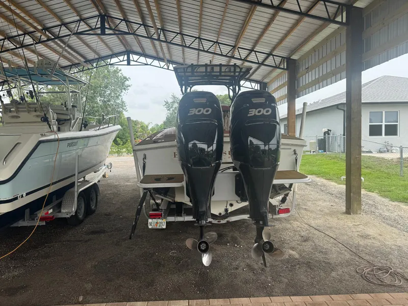 Slide: The Image of Twin outboard motors on a 2008 Avanti 36 boat, reflecting sky and surroundings. - 3