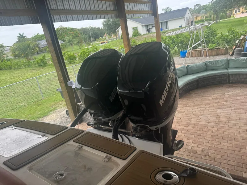 Slide: The Image of 2008 Avanti 36 boat with tan seating and black T-top, parked outdoors. - 6