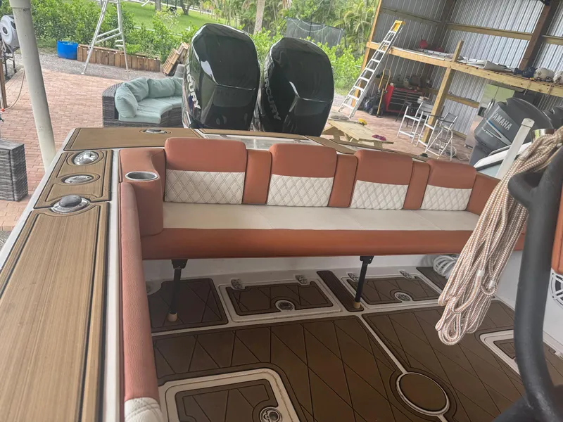 Slide: The Image of 2008 Avanti 36 boat interior with cushioned seating and dual outboard motors. - 8