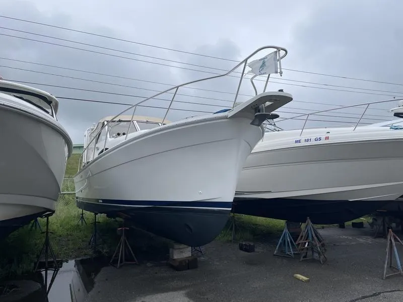 Slide: The Image of 2003 Mainship Pilot 30-II boat on stands, overcast sky background. - 13