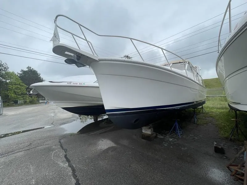 Slide: The Image of 2003 Mainship Pilot 30-II boat on dry dock, overcast sky, side view. - 15