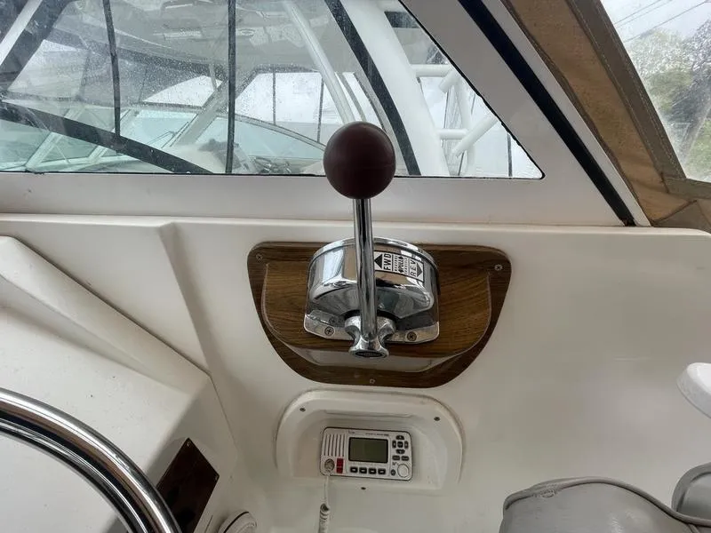 Slide: The Image of 2003 Mainship Pilot 30-II boat control panel with throttle and radio. - 5