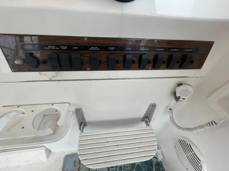 Slide: The Image of Control panel of a 2003 Mainship Pilot 30-II boat with switches and microphone. - 6