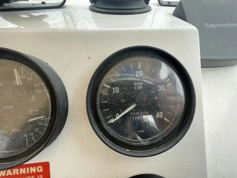 Slide: The Image of Close-up of Mainship Pilot 30-II 2003 boat dashboard gauges, showing RPM and engine hours. - 9