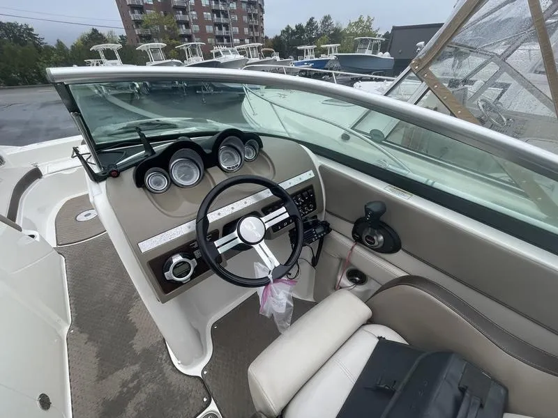 Slide: The Image of 2012 Sea Ray 260 Sundeck boat interior with steering wheel and dashboard controls. - 10