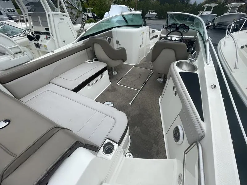 Slide: The Image of 2012 Sea Ray 260 Sundeck interior with seating and helm, showcasing spacious design. - 11