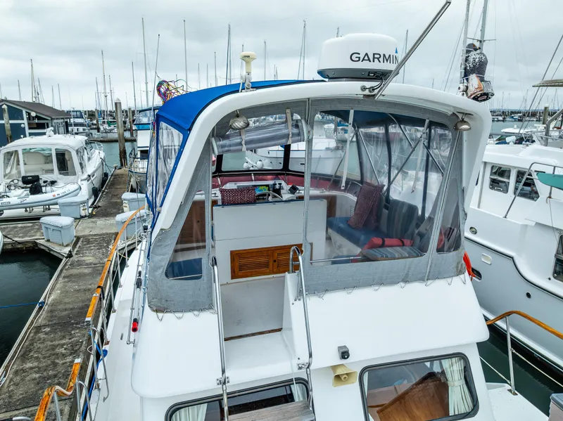 Slide: The Image of 1986 Kha Shing 37' yacht docked at marina, featuring Garmin equipment and blue canopy. - 10