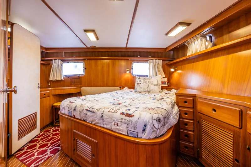 Slide: The Image of Cozy cabin interior of 1986 Kha Shing 37' yacht with wood paneling and bed. - 11