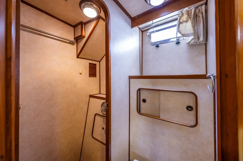 Slide: The Image of 1986 Kha Shing 37' yacht interior bathroom with wooden accents and small window. - 12