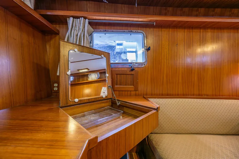 Slide: The Image of 1986 Kha Shing 37' yacht interior with wooden desk, mirror, and window. - 13