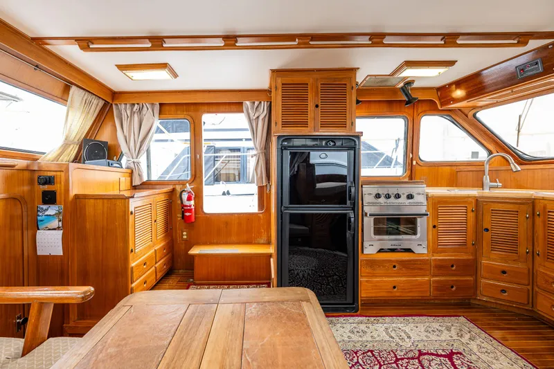 Slide: The Image of Interior of 1986 Kha Shing 37' yacht with wooden cabinetry and modern appliances. - 19