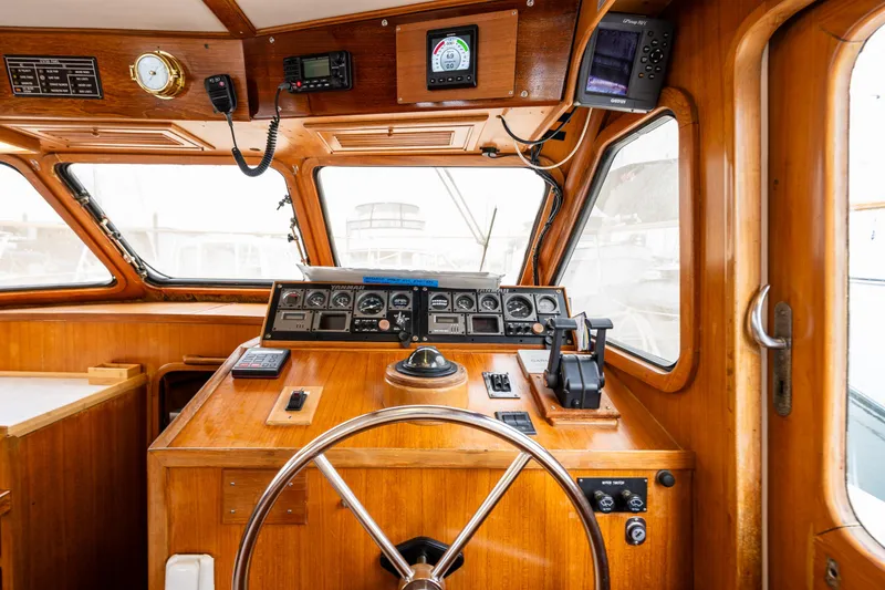 Slide: The Image of 1986 Kha Shing 37' boat helm with wooden dashboard and navigation instruments. - 21