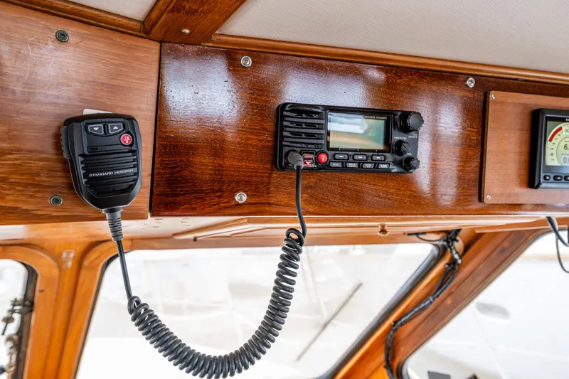 Slide: The Image of 1986 Kha Shing 37' yacht radio equipment on polished wooden panel. - 27