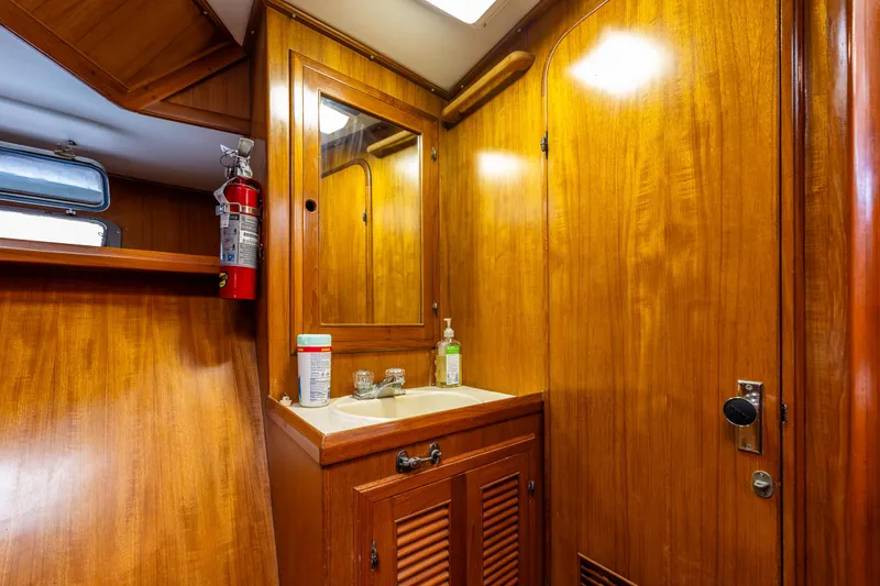 Slide: The Image of 1986 Kha Shing 37' yacht bathroom with wooden cabinetry and sink. - 30