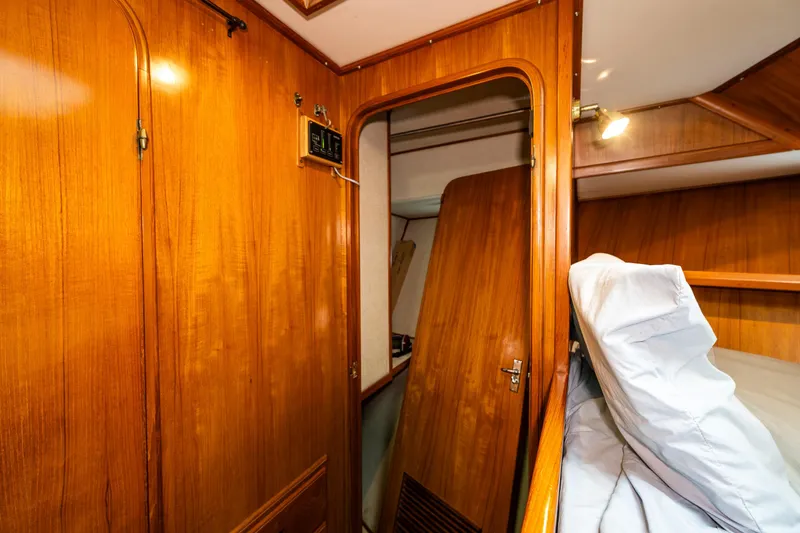Slide: The Image of Interior of 1986 Kha Shing 37' yacht with wooden paneling and cozy sleeping area. - 31