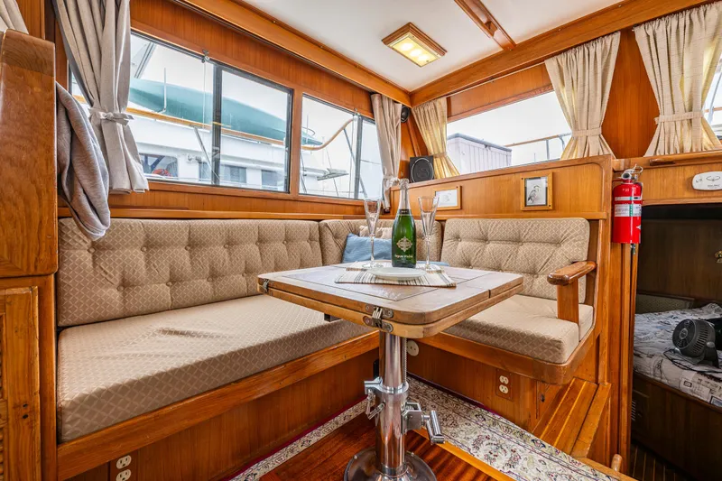 Slide: The Image of Interior of 1986 Kha Shing 37' yacht with cozy seating and dining area. - 35