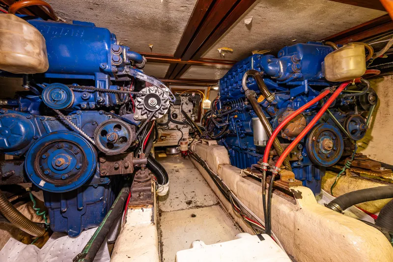 Slide: The Image of Engine room of a 1986 Kha Shing 37' yacht with dual blue engines. - 38