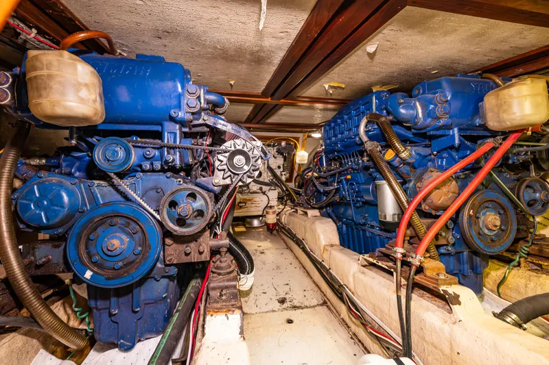 Slide: The Image of Engine room of 1986 Kha Shing 37' yacht with dual blue engines. - 39