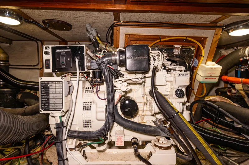 Slide: The Image of Engine room of a 1986 Kha Shing 37' yacht, featuring detailed mechanical components. - 41