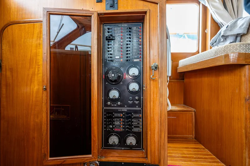 Slide: The Image of 1986 Kha Shing 37' yacht interior with control panel and wooden cabinetry. - 42