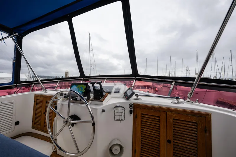 Slide: The Image of Interior view of 1986 Kha Shing 37' yacht helm with steering wheel and navigation equipment. - 45