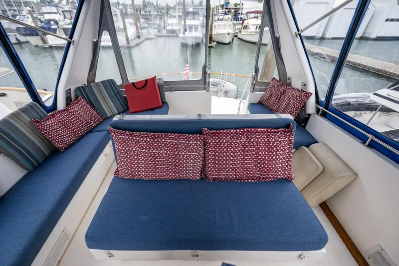 Slide: The Image of Cozy seating area on a 1986 Kha Shing 37' yacht with colorful cushions. - 47