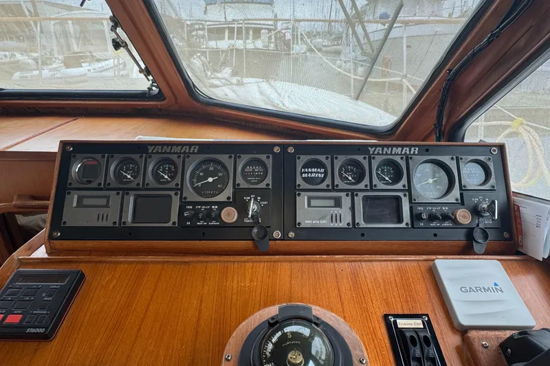 Slide: The Image of 1986 Kha Shing 37' yacht dashboard with Yanmar gauges and Garmin navigation system. - 52