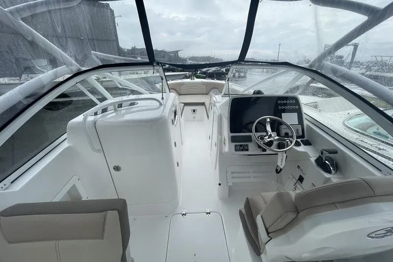 Slide: The Image of 2024 Edgewater 248CX boat interior with modern dashboard and seating. - 4
