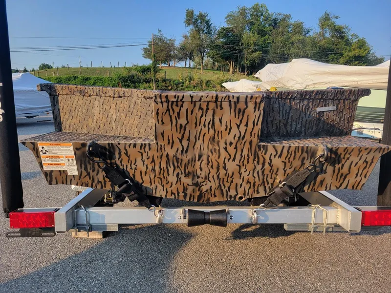 Slide: The Image of 2025 Xpress XTS16 duck hunting boat with camouflage design on a trailer. - 3
