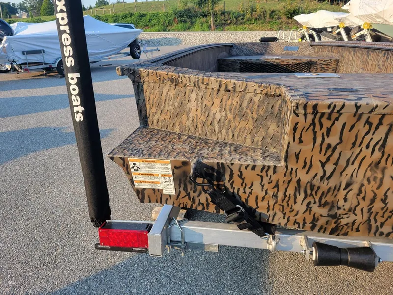 Slide: The Image of 2025 Xpress XTS16 duck hunting boat with camouflage design and trailer, featuring Yamaha 50 hp engine. - 9
