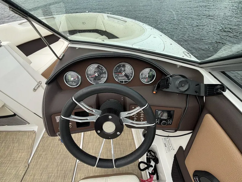 Slide: The Image of Steering wheel and dashboard of a 2018 Cobalt 220S boat on water. - 16
