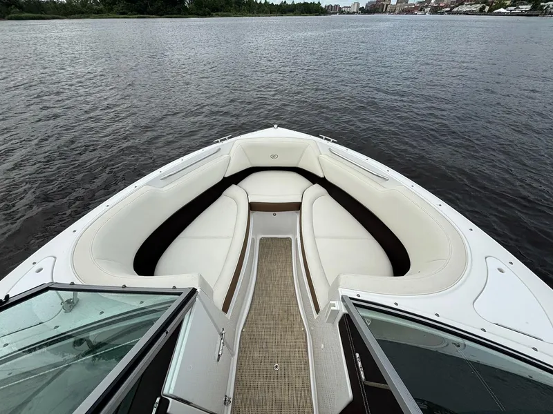 Slide: The Image of 2018 Cobalt 220S boat with white seating, open bow, on calm water. - 2
