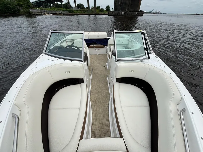 Slide: The Image of 2018 Cobalt 220S boat with white interior, docked on a calm river. - 3