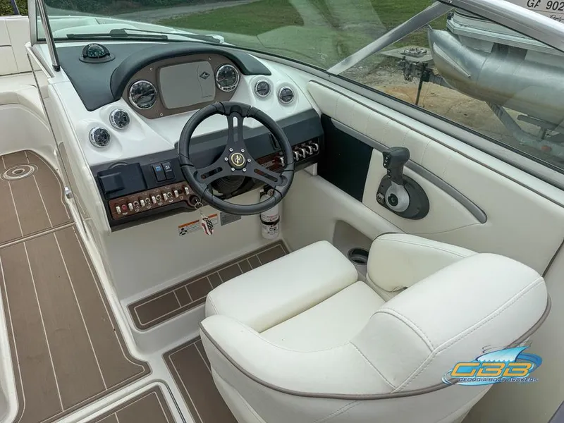 Slide: The Image of 2008 Sea Ray 270 SLX boat cockpit with steering wheel and control panel. - 12