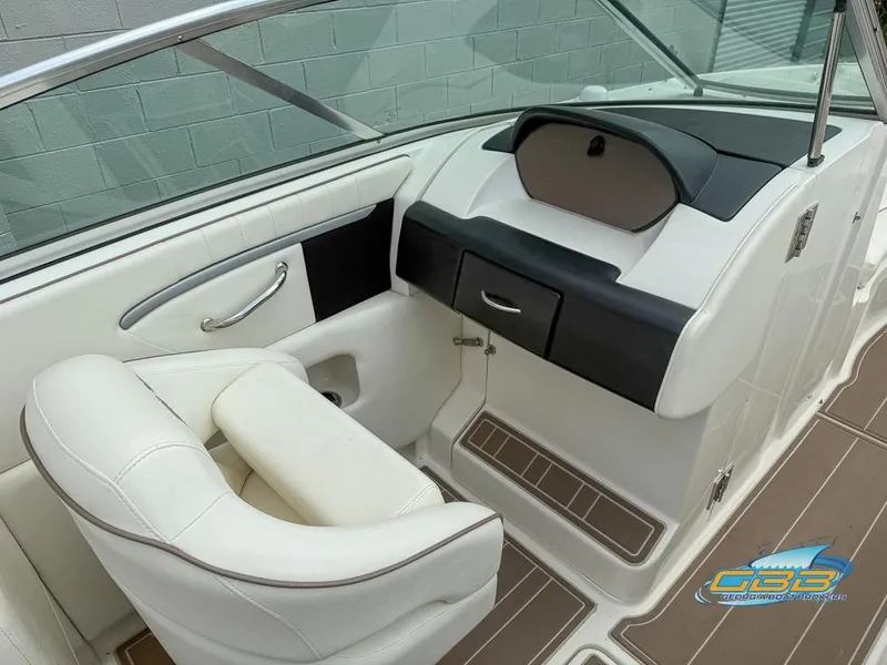 Slide: The Image of 2008 Sea Ray 270 SLX boat interior with white seating and dashboard. - 13