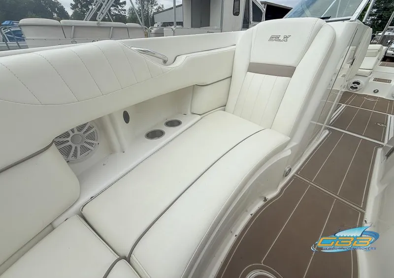 Slide: The Image of 2008 Sea Ray 270 SLX boat interior with white leather seating and cup holders. - 17
