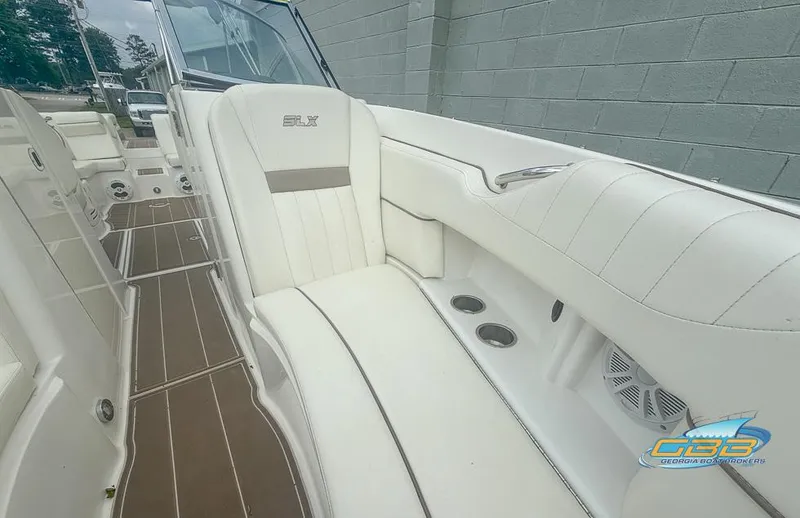 Slide: The Image of 2008 Sea Ray 270 SLX boat interior with white leather seating and wood flooring. - 18