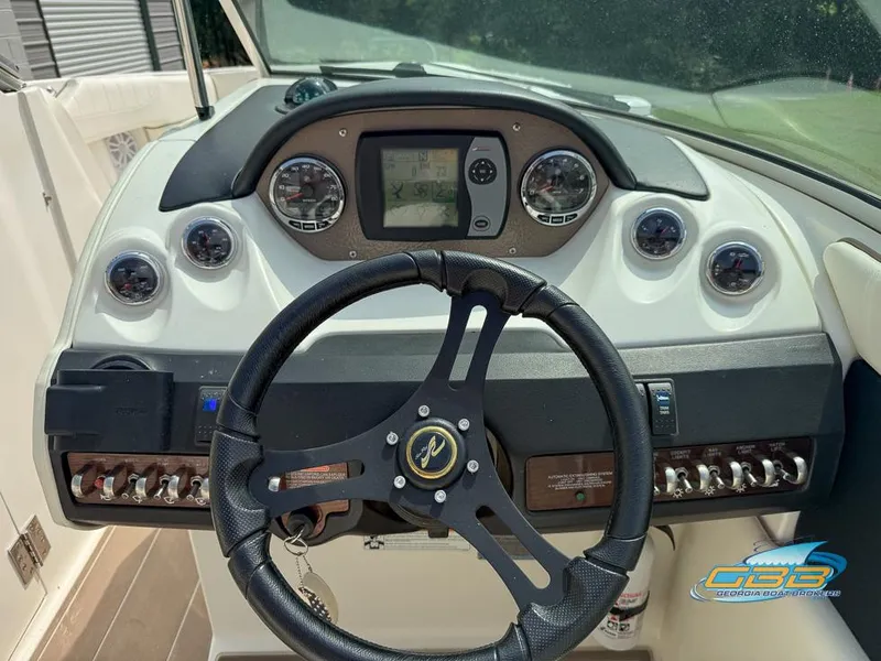 Slide: The Image of Dashboard of a 2008 Sea Ray 270 SLX boat with steering wheel and gauges. - 22