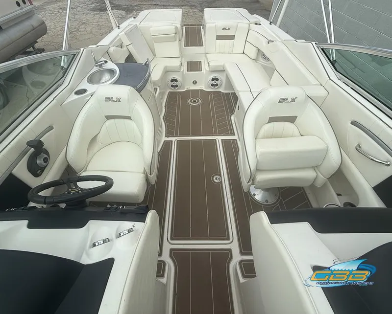 Slide: The Image of 2008 Sea Ray 270 SLX boat interior with white seating and brown flooring. - 26