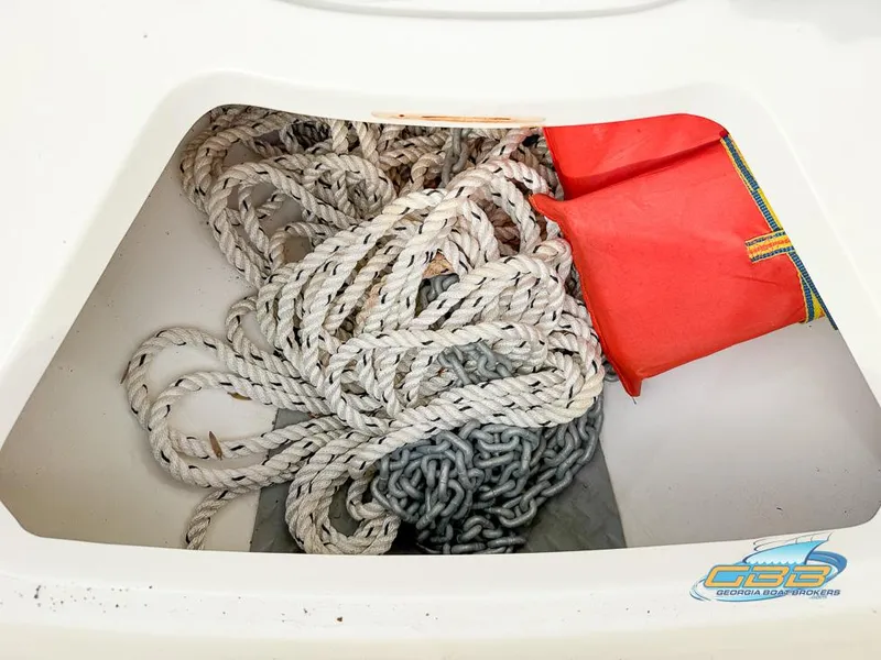 Slide: The Image of Storage compartment with rope and chain on a 2008 Sea Ray 270 SLX boat. - 32
