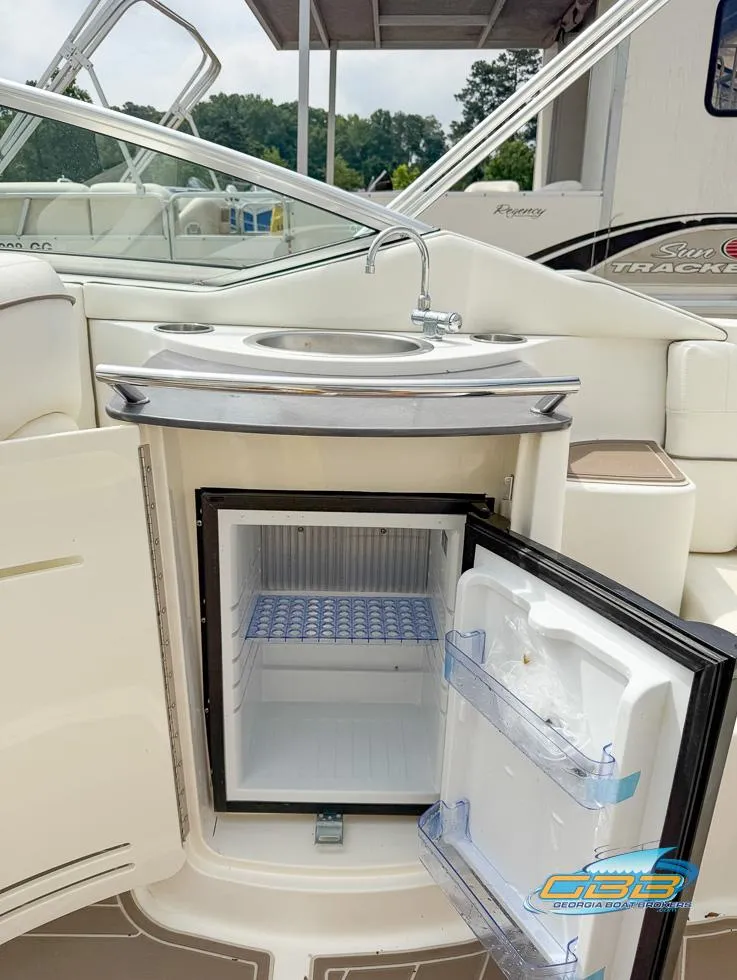 Slide: The Image of 2008 Sea Ray 270 SLX boat with open mini fridge and sink on deck. - 38