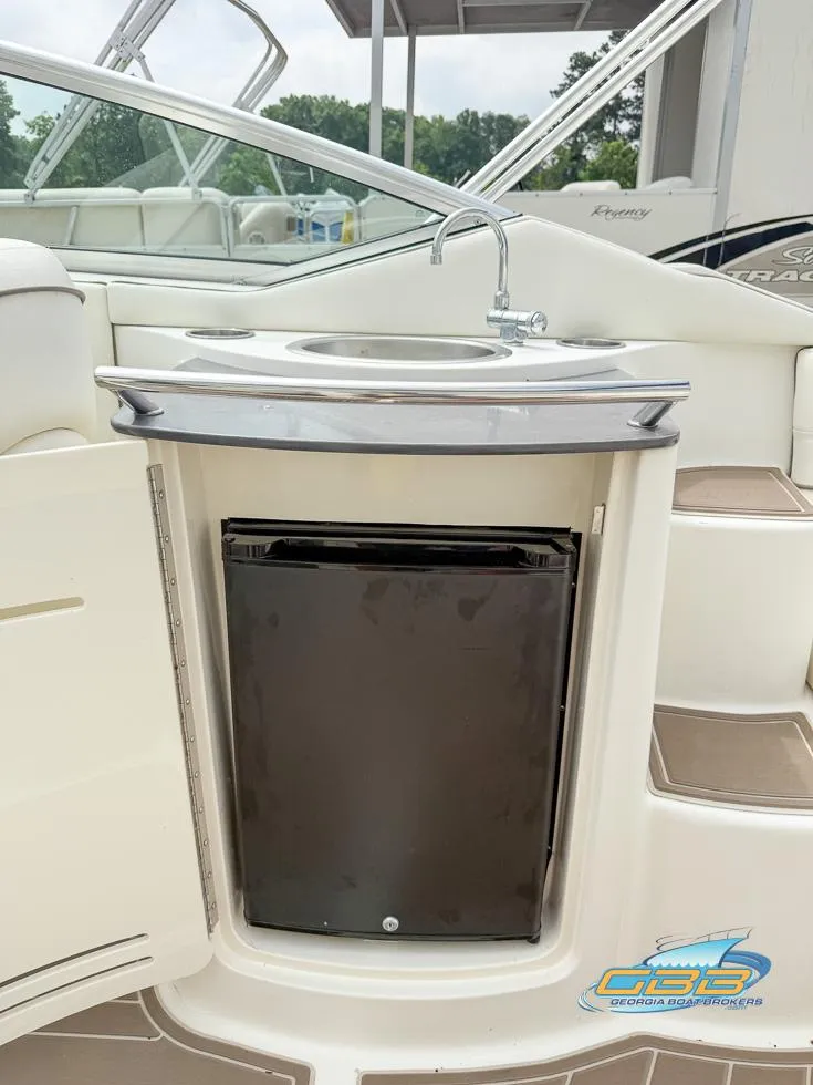 Slide: The Image of 2008 Sea Ray 270 SLX boat interior with sink and mini fridge. - 39